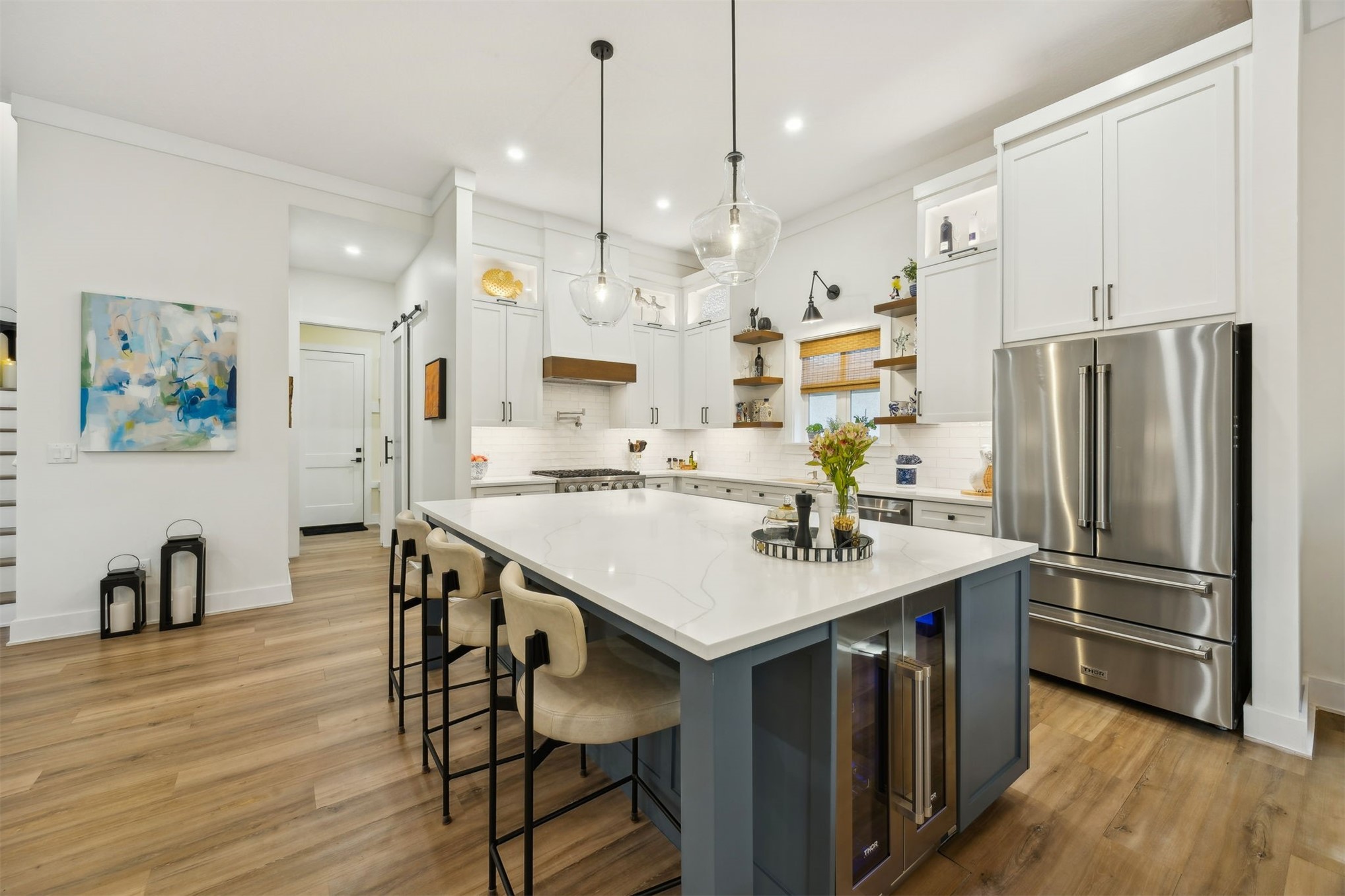 45 Beachwood Road Amelia Island, FL 32034 - Photo 5 of 41 a kitchen with stainless steel appliances a table chairs wooden floors and a large window