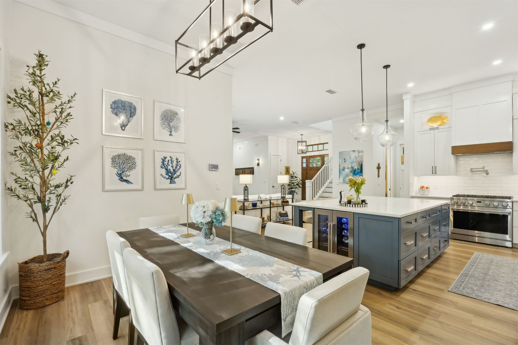45 Beachwood Road Amelia Island, FL 32034 - Photo 8 of 41 a large kitchen with kitchen island a stove a sink a dining table and chairs with wooden floor