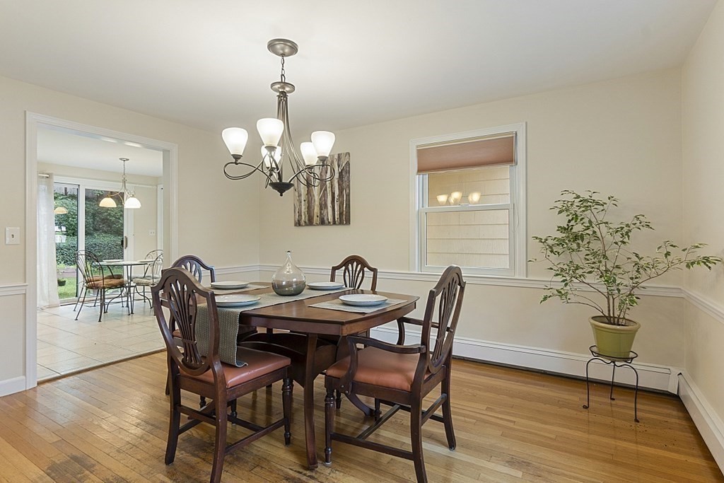 5 Alpine Circle Wakefield, MA 01880 - Photo 15 of 42 a dining room with furniture wooden floor a potted plant and a chandelier