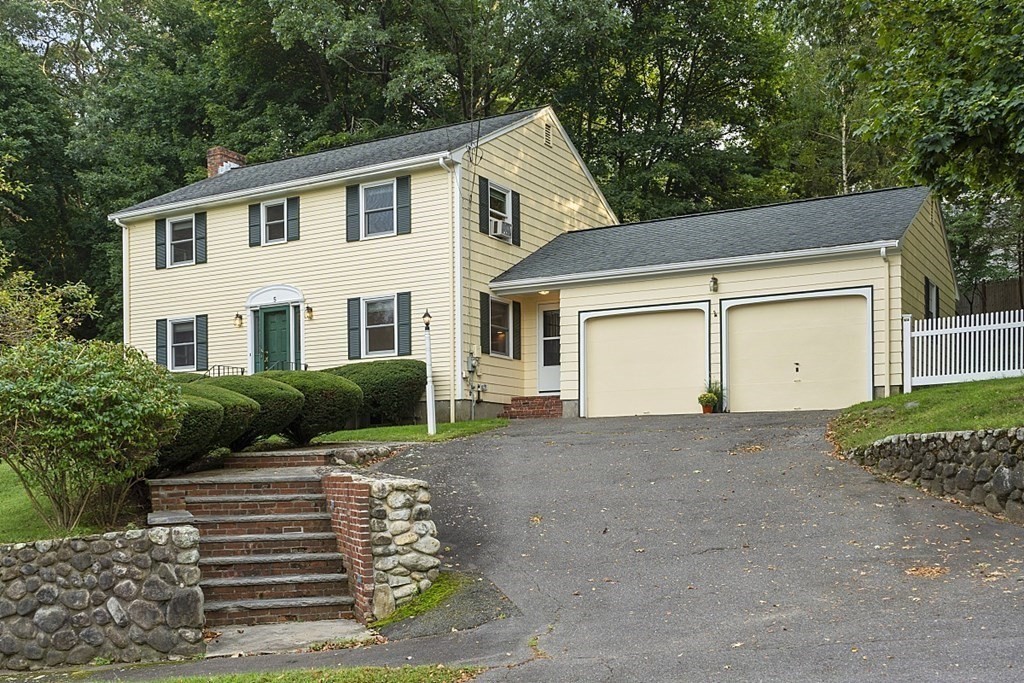 5 Alpine Circle Wakefield, MA 01880 - Photo 2 of 42 a front view of a house with a yard and garage