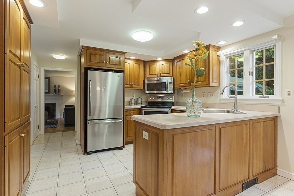 5 Alpine Circle Wakefield, MA 01880 - Photo 22 of 42 a kitchen with stainless steel appliances kitchen island granite countertop a refrigerator and a sink
