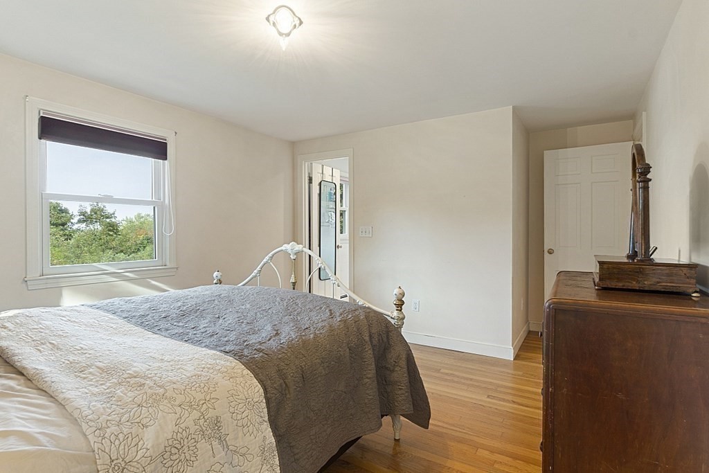 5 Alpine Circle Wakefield, MA 01880 - Photo 27 of 42 a bedroom with a bed and wooden floor