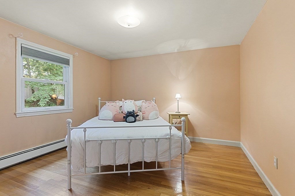5 Alpine Circle Wakefield, MA 01880 - Photo 29 of 42 a bedroom with a bed and wooden floor