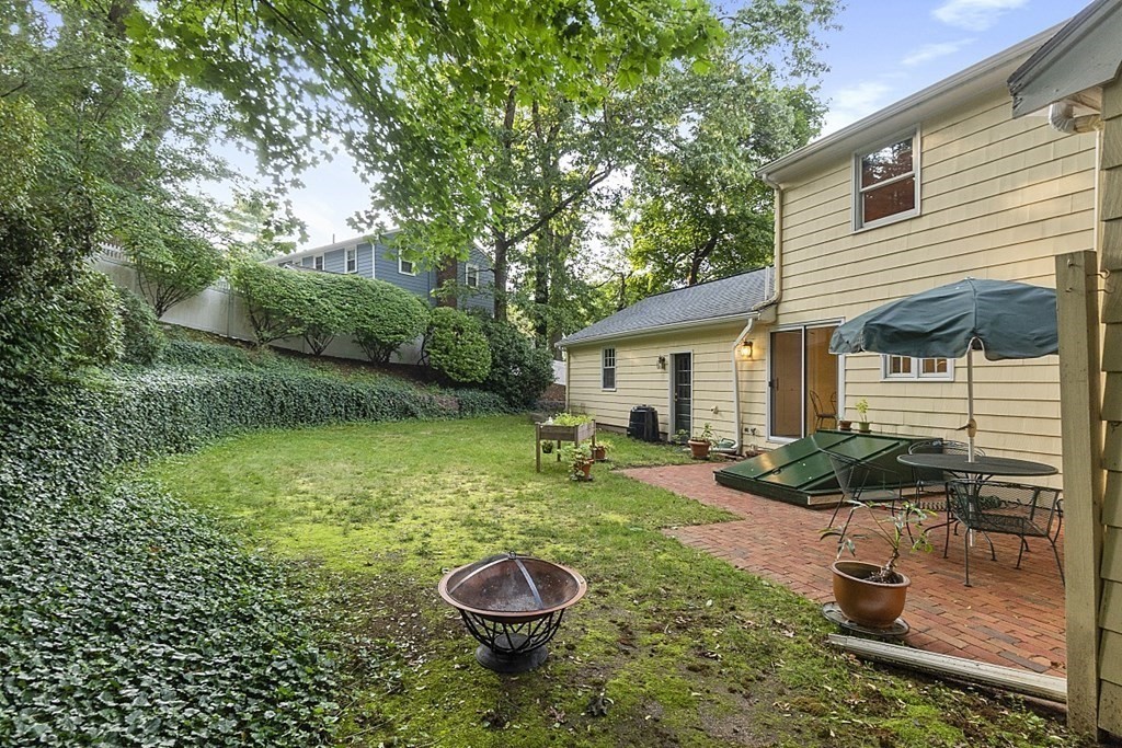 5 Alpine Circle Wakefield, MA 01880 - Photo 4 of 42 a view of a backyard with table and chairs and potted plants