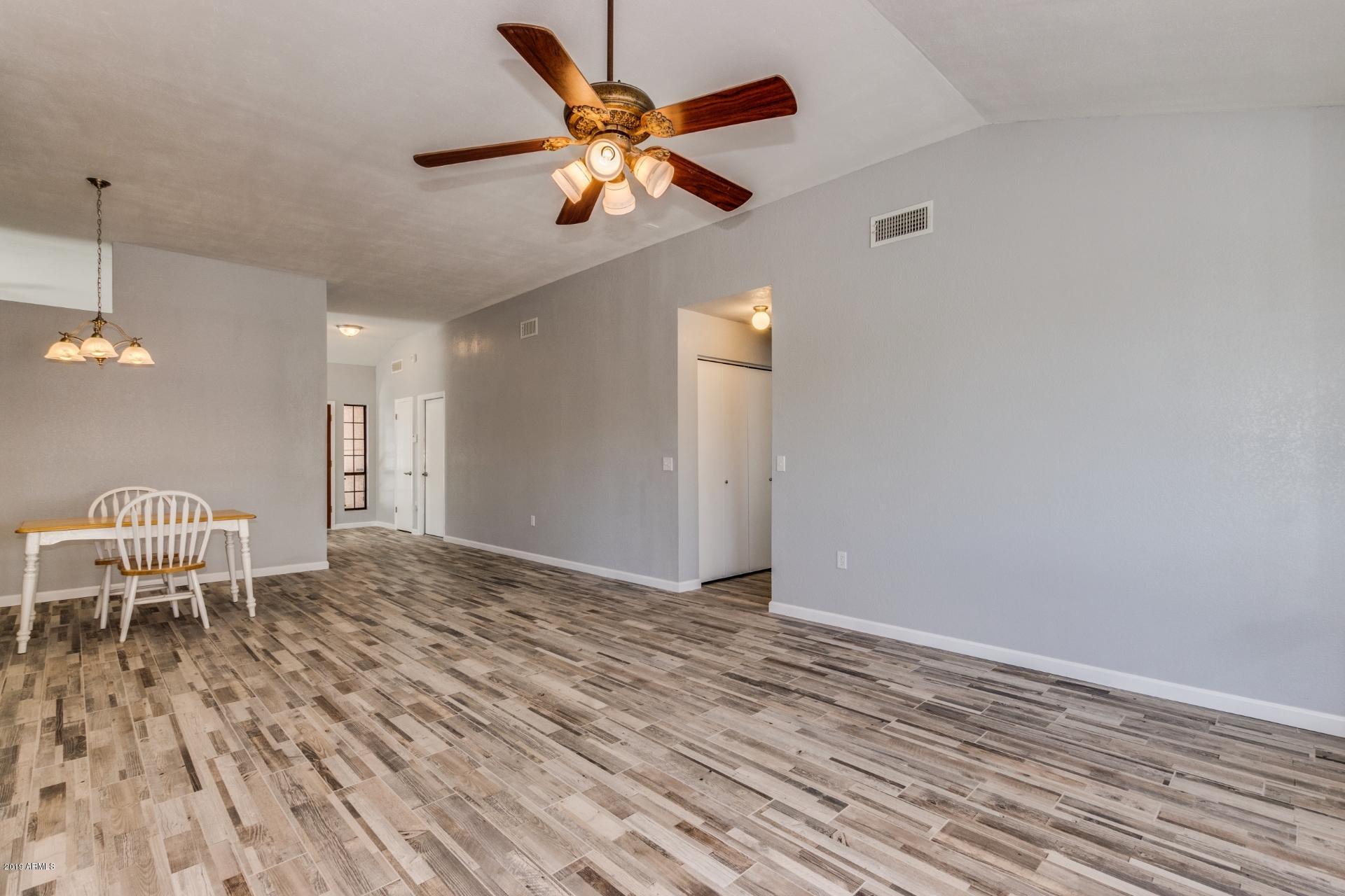 4812 East Gary Street Mesa, AZ 85205 - Photo 14 of 37 a view of a livingroom with a chair and wooden floor