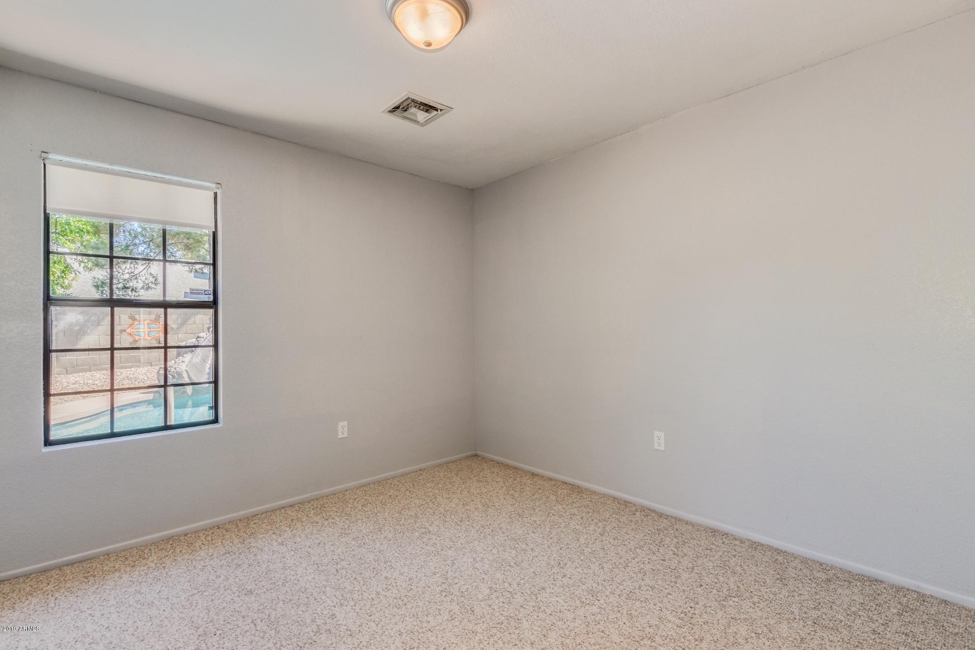 4812 East Gary Street Mesa, AZ 85205 - Photo 23 of 37 an empty room with windows