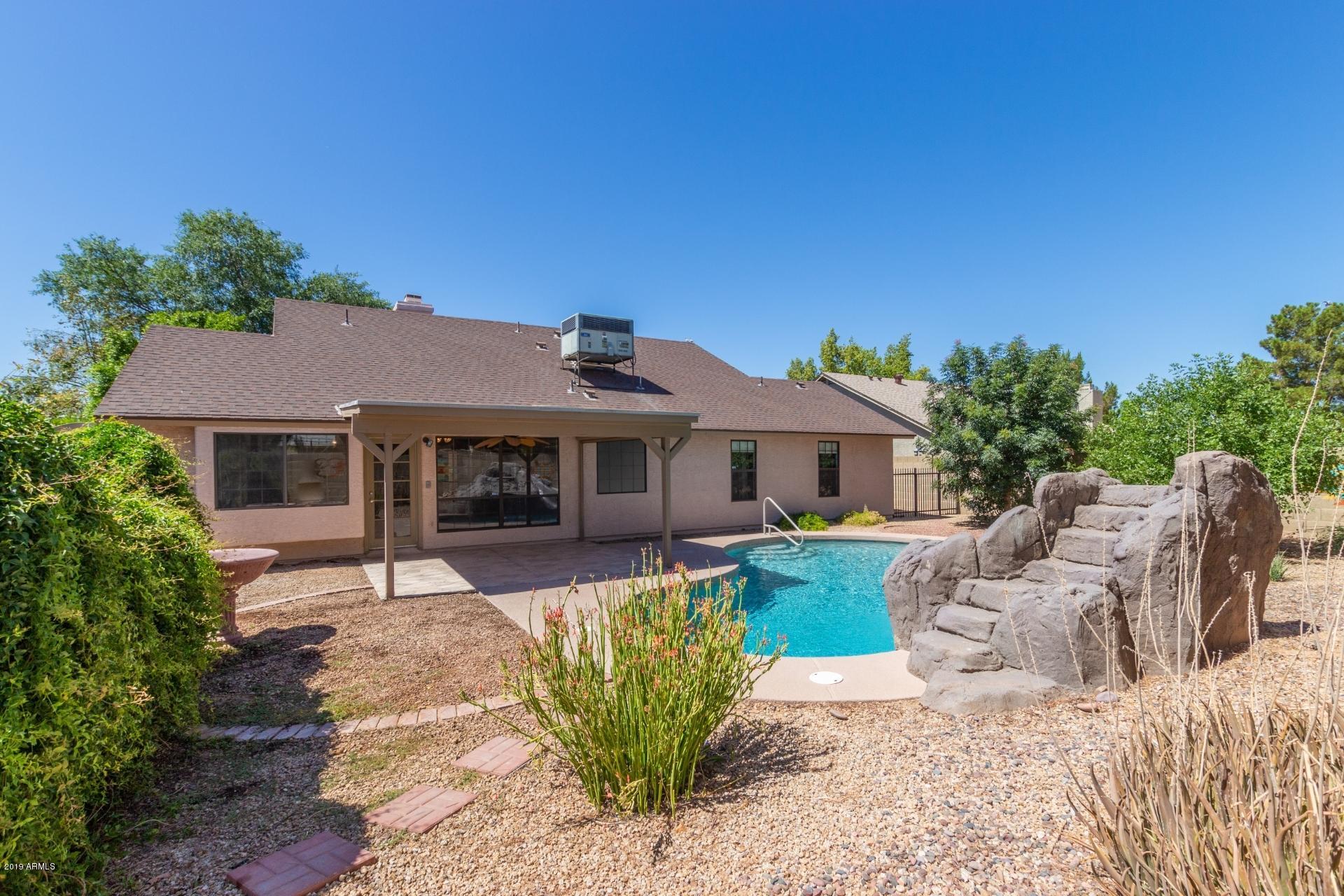 4812 East Gary Street Mesa, AZ 85205 - Photo 34 of 37 a front view of a house with a garden and patio