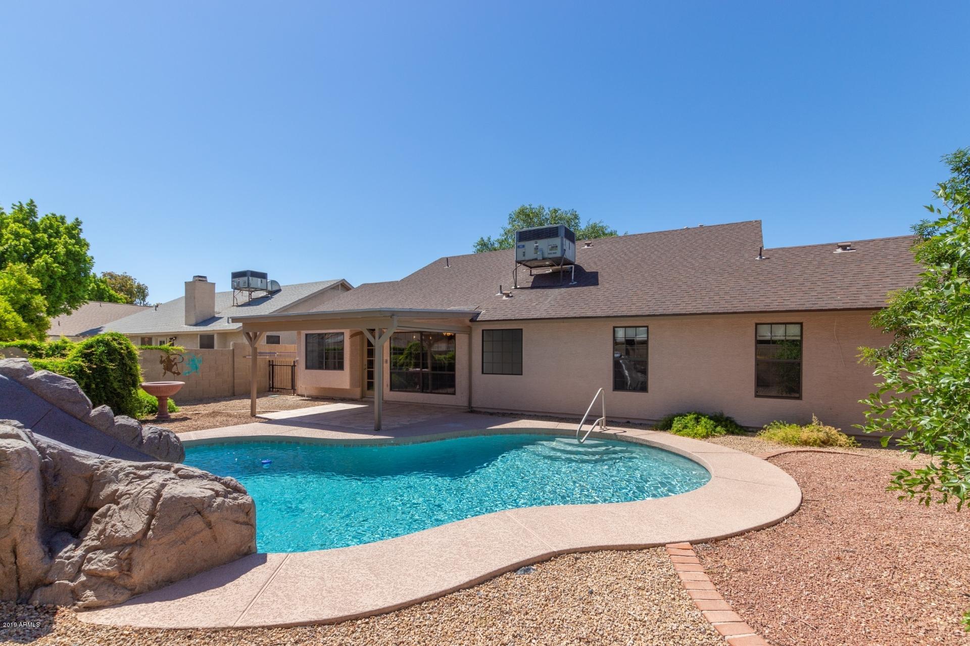 4812 East Gary Street Mesa, AZ 85205 - Photo 35 of 37 a front view of a house with a yard and garage