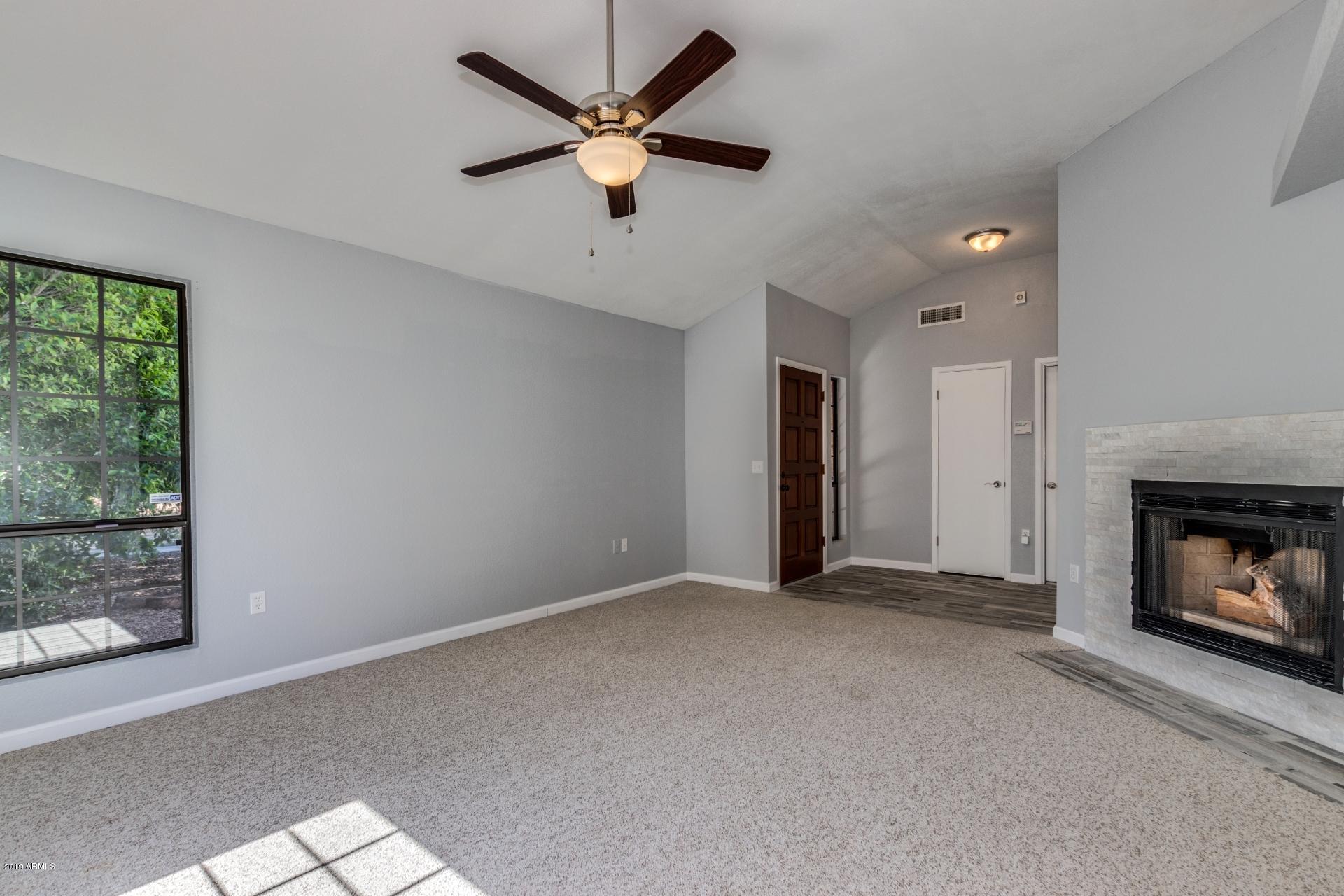 4812 East Gary Street Mesa, AZ 85205 - Photo 5 of 37 an empty room with fan and windows