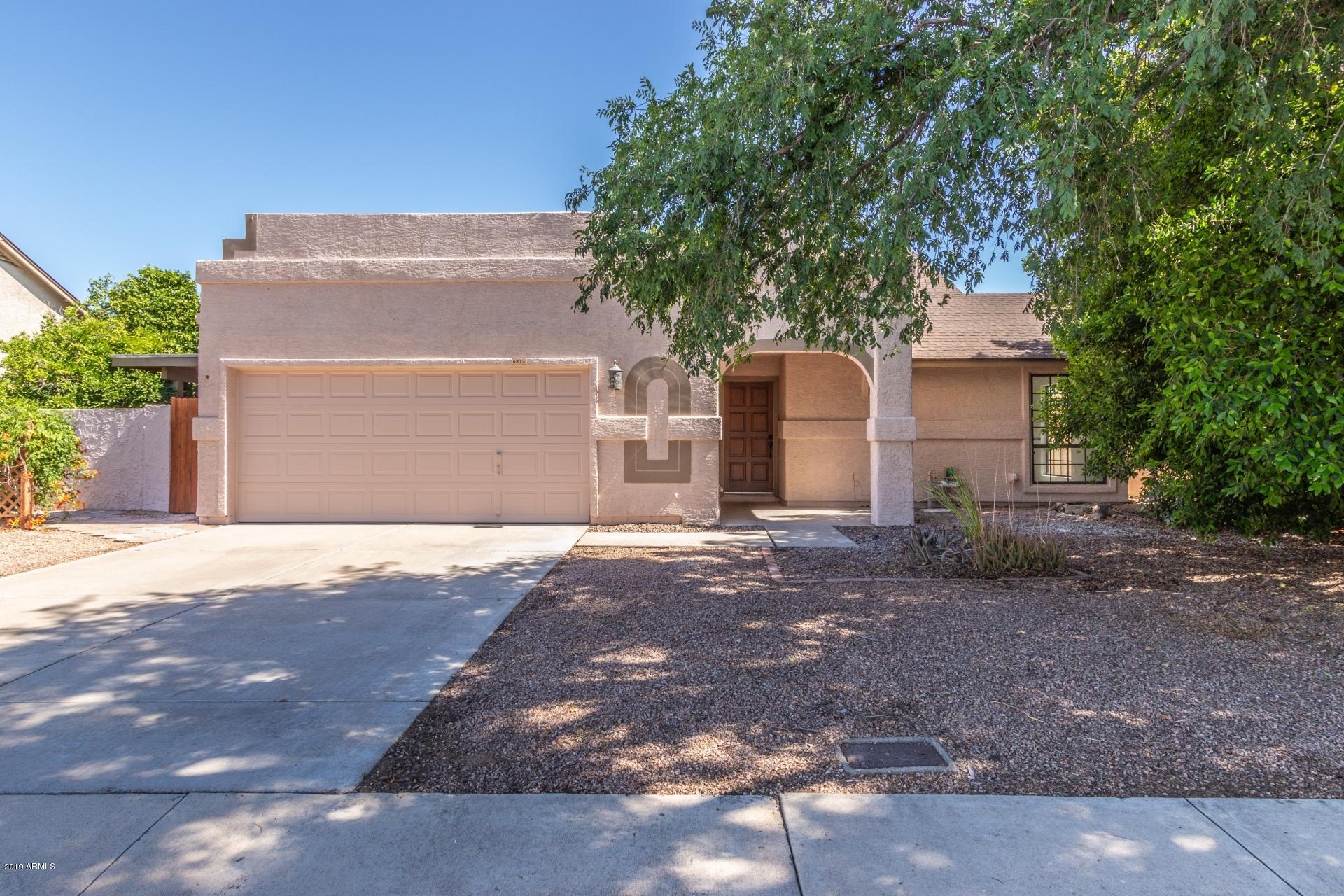 4812 East Gary Street Mesa, AZ 85205 - Photo 6 of 37 a front view of a house with a yard and garage