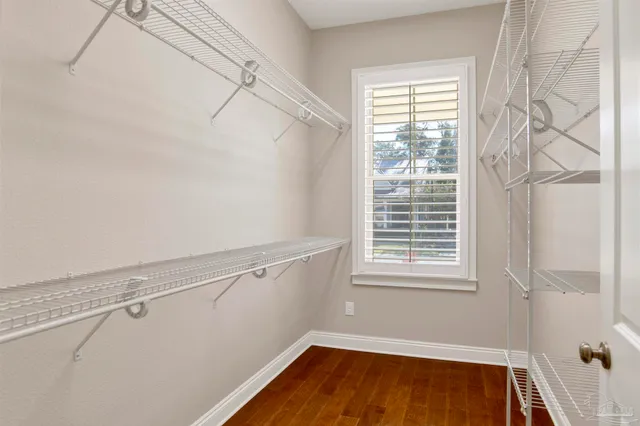 a view of a room with racks on the wall and a window