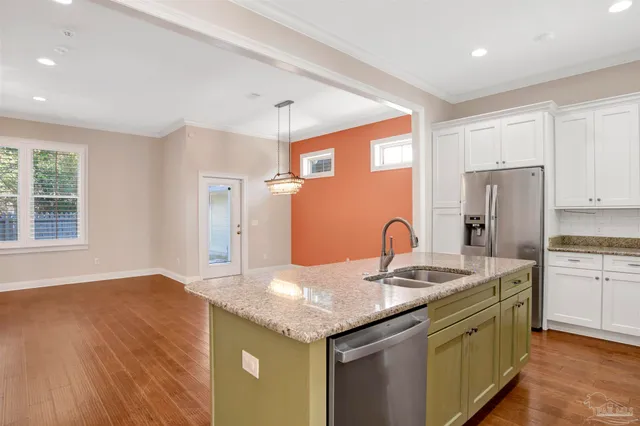 a kitchen with stainless steel appliances granite countertop a sink stove and refrigerator
