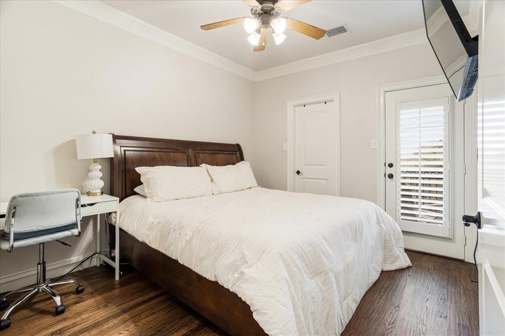 7940 Bishop Road Plano, TX 75024 - Photo 12 of 36 a bedroom with a bed and a chandelier