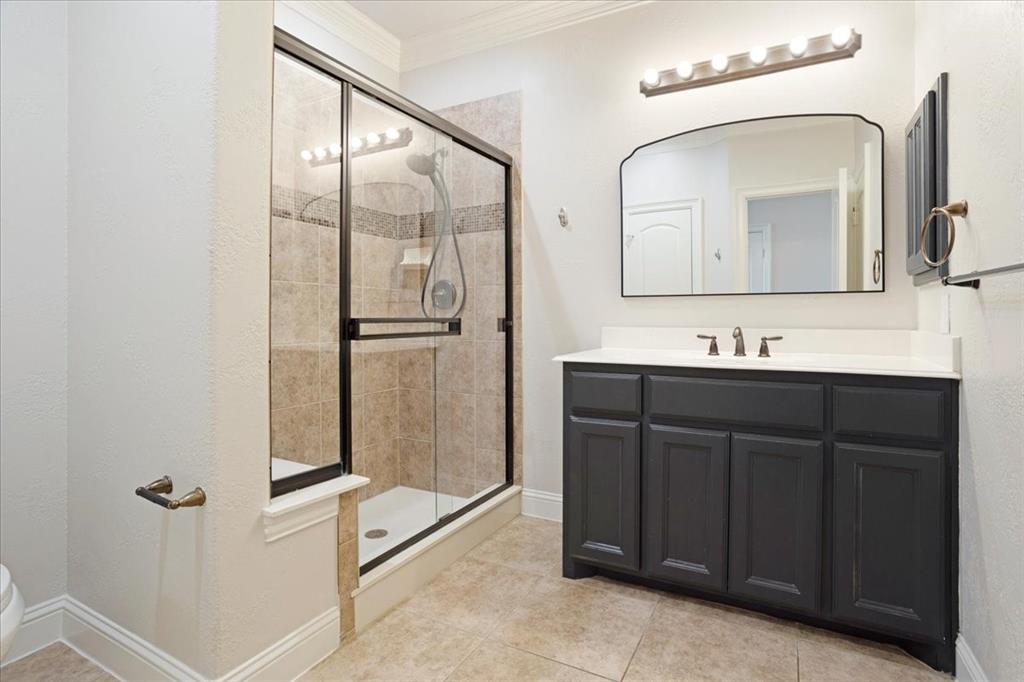 7940 Bishop Road Plano, TX 75024 - Photo 13 of 36 a bathroom with a double vanity sink and mirror