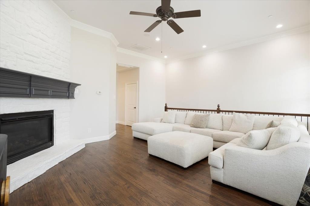7940 Bishop Road Plano, TX 75024 - Photo 16 of 36 a living room with furniture and a fireplace