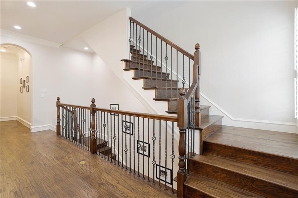 7940 Bishop Road Plano, TX 75024 - Photo 17 of 36 a view of staircase with lots of frames on wall and wooden floor