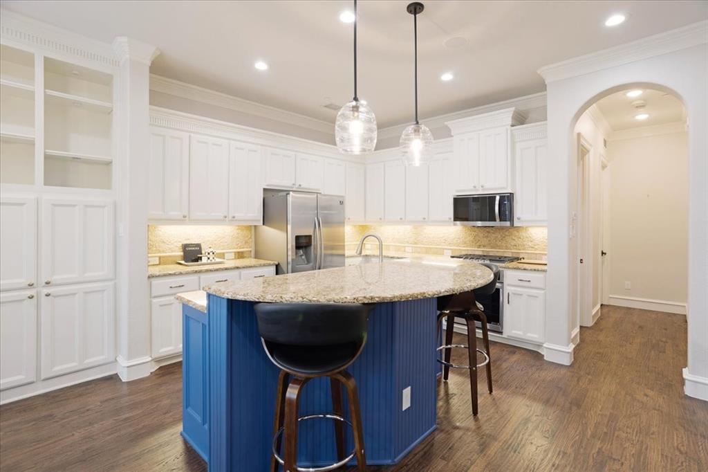 7940 Bishop Road Plano, TX 75024 - Photo 23 of 36 a kitchen with stainless steel appliances granite countertop a table chairs sink refrigerator and microwave