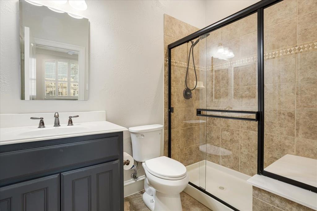 7940 Bishop Road Plano, TX 75024 - Photo 7 of 36 a bathroom with a sink a toilet and shower