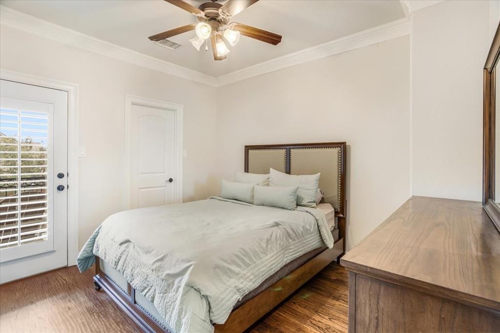 7940 Bishop Road Plano, TX 75024 - Photo 10 of 36 a bedroom with a large bed and a chandelier