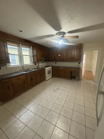 a kitchen with stainless steel appliances granite countertop a sink and cabinets