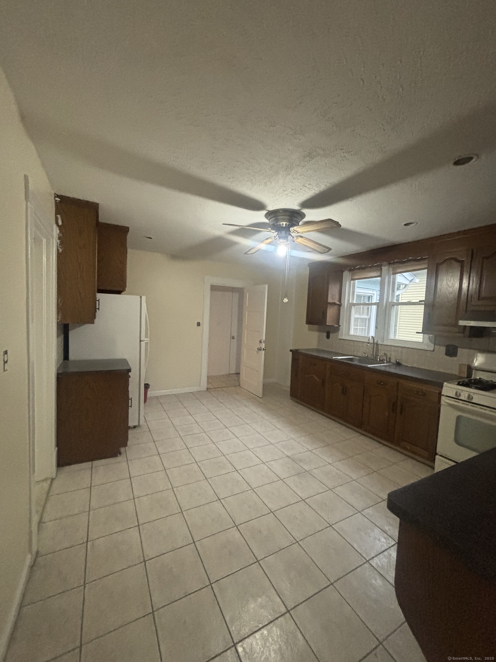 85 South Burritt Street, Unit 3 New Britain, CT 06052 - Photo 2 of 11 a large room with a large window and furniture