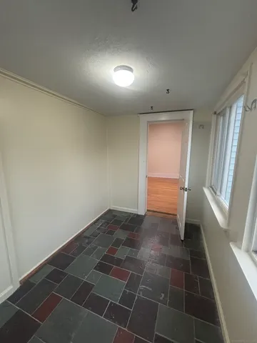 a view of an empty room and a window