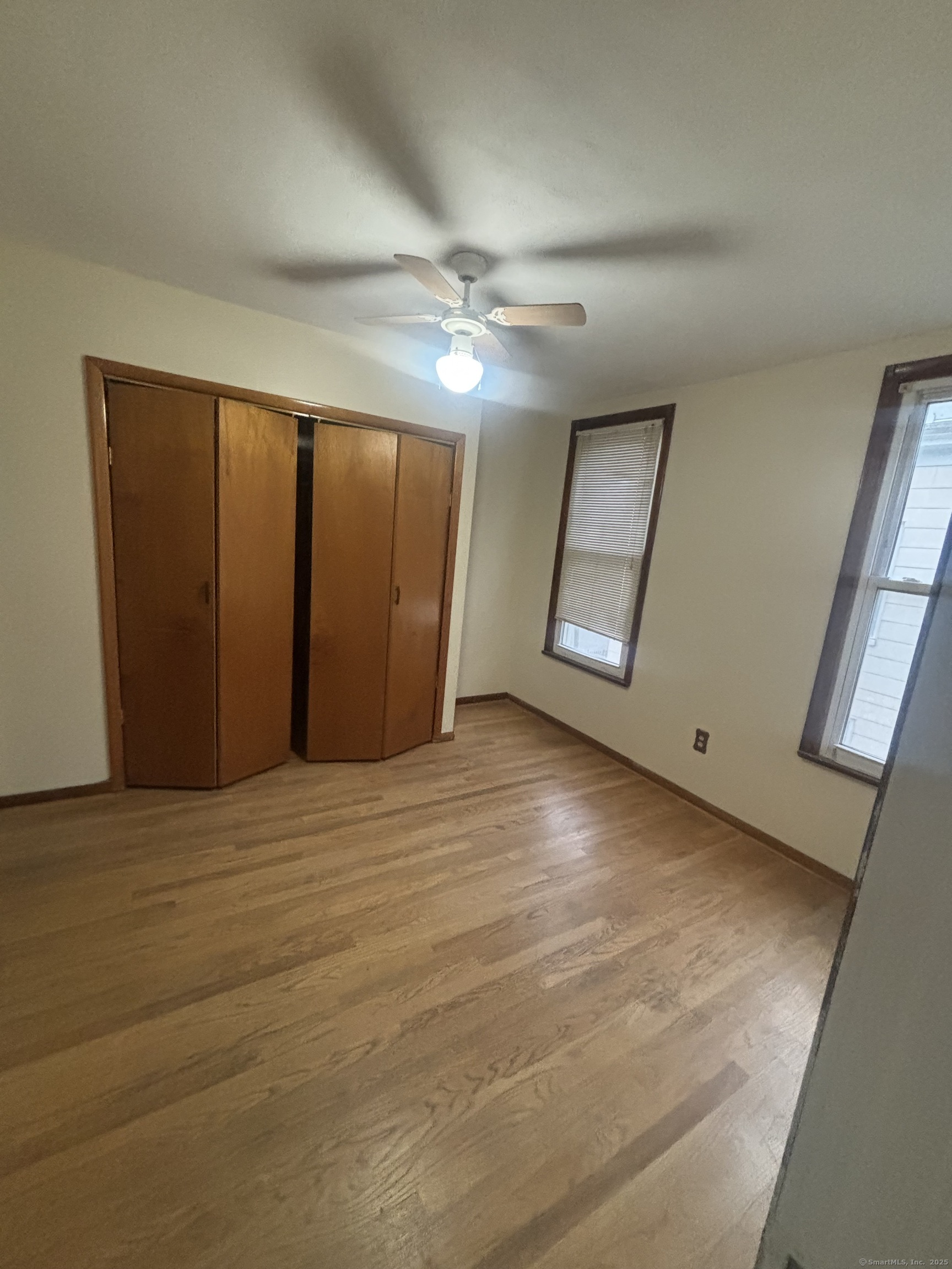 85 South Burritt Street, Unit 3 New Britain, CT 06052 - Photo 8 of 11 en empty room with windows and ceiling fan