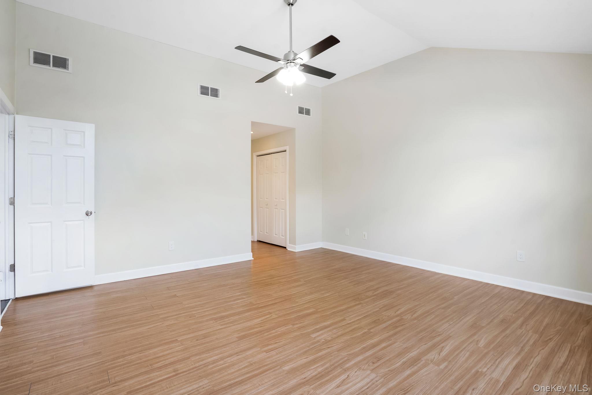 400 Eastport Manor Road Manorville, NY 11949 - Photo 15 of 29 a view of an empty room with wooden floor