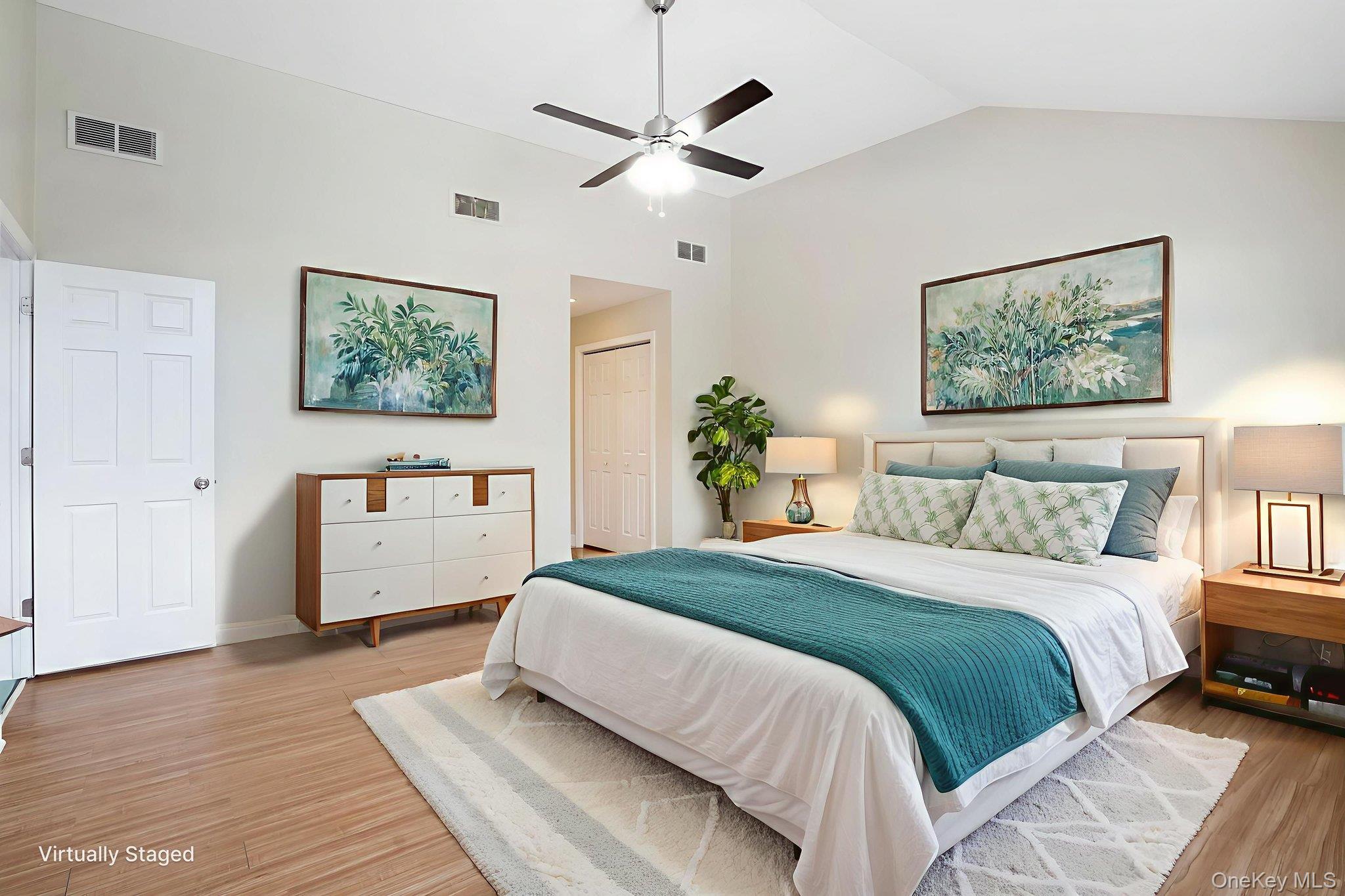 400 Eastport Manor Road Manorville, NY 11949 - Photo 16 of 29 a bedroom with a large bed and a chandelier