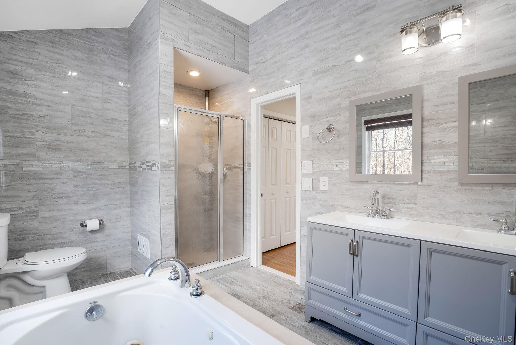 400 Eastport Manor Road Manorville, NY 11949 - Photo 17 of 29 a bathroom with a sink and mirror with toilet