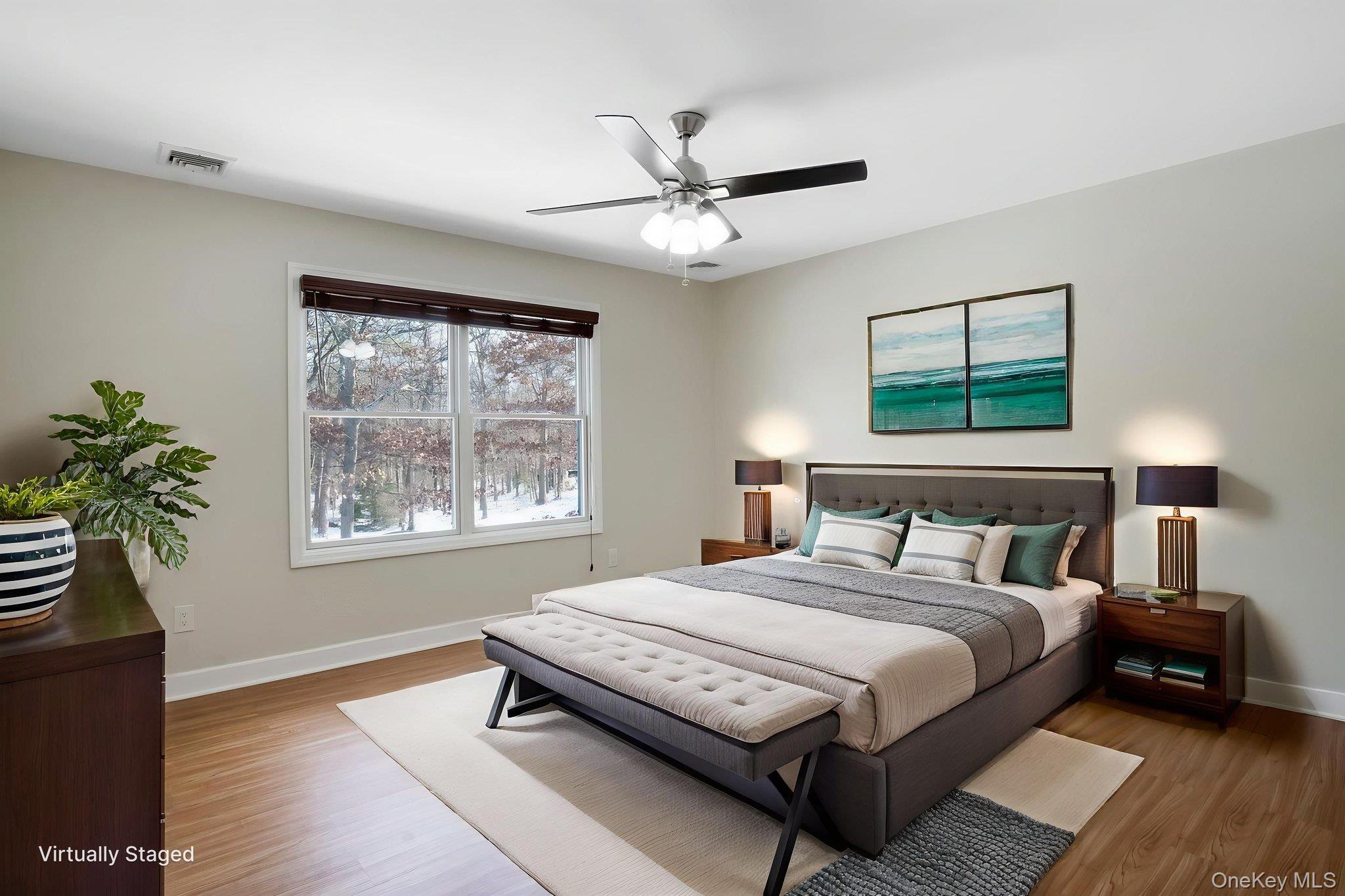 400 Eastport Manor Road Manorville, NY 11949 - Photo 21 of 29 a bedroom with a bed and a window