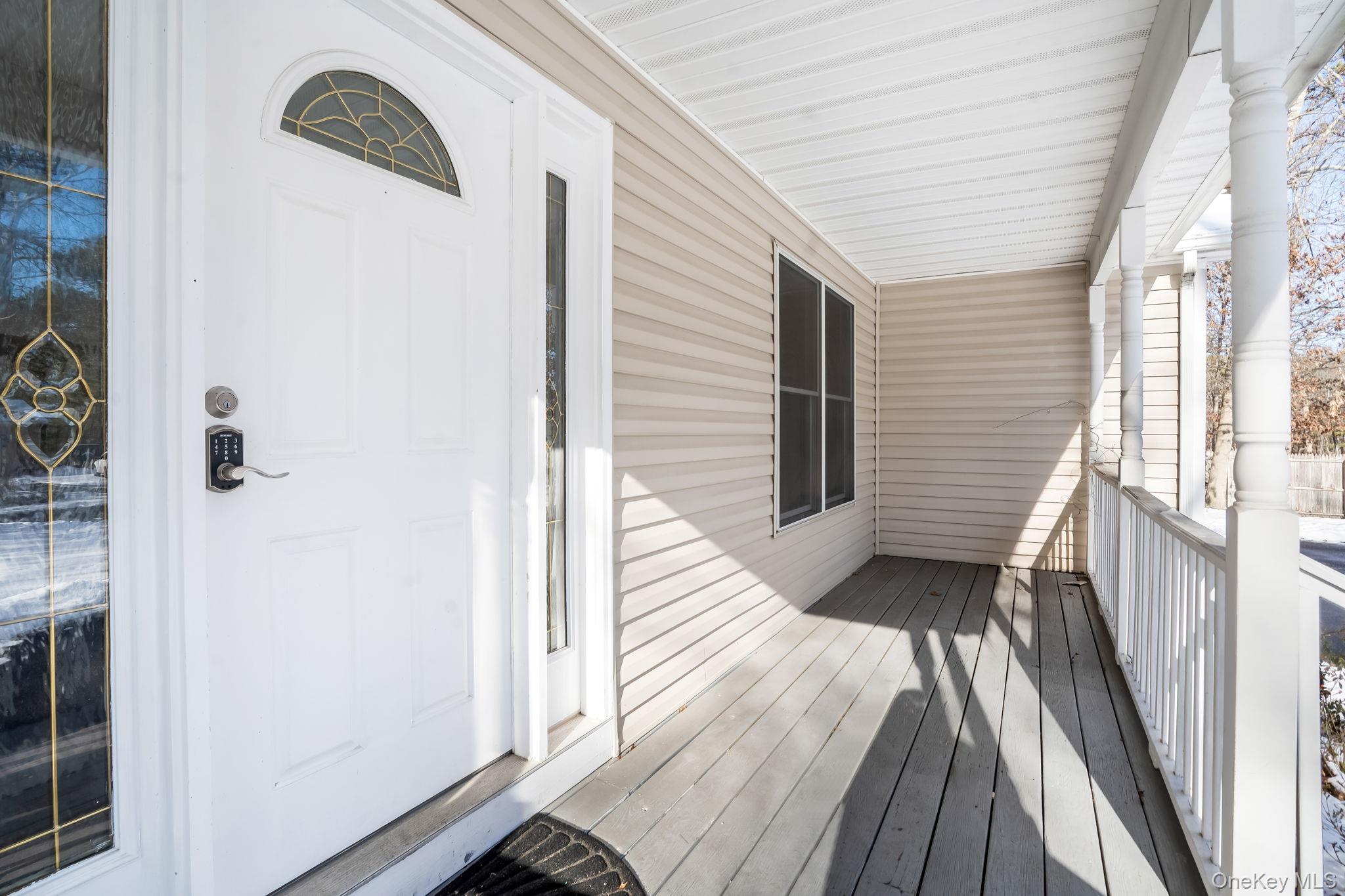 400 Eastport Manor Road Manorville, NY 11949 - Photo 3 of 29 a view of a hallway and wooden floor