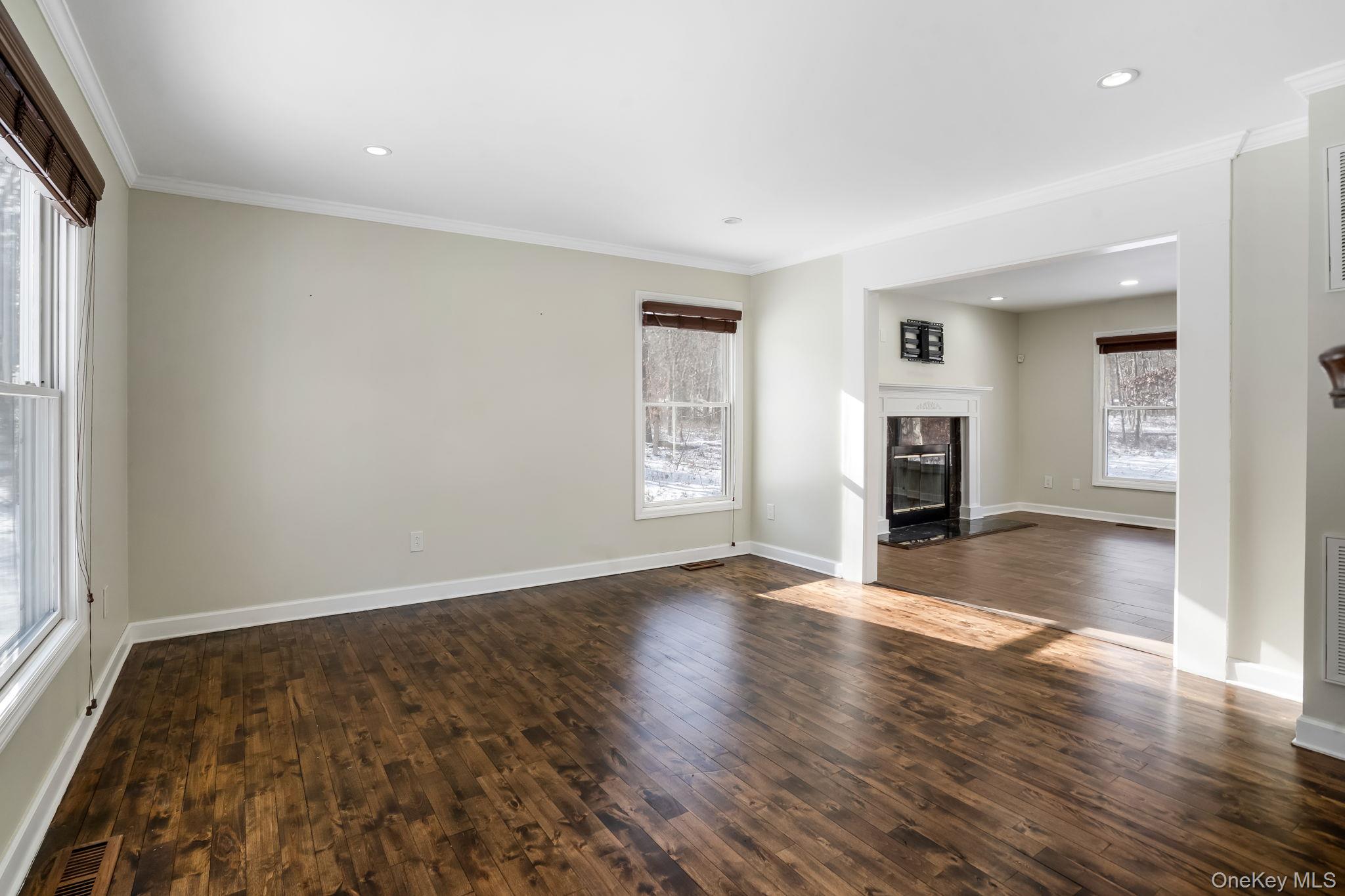 400 Eastport Manor Road Manorville, NY 11949 - Photo 4 of 29 an empty room with wooden floor and windows