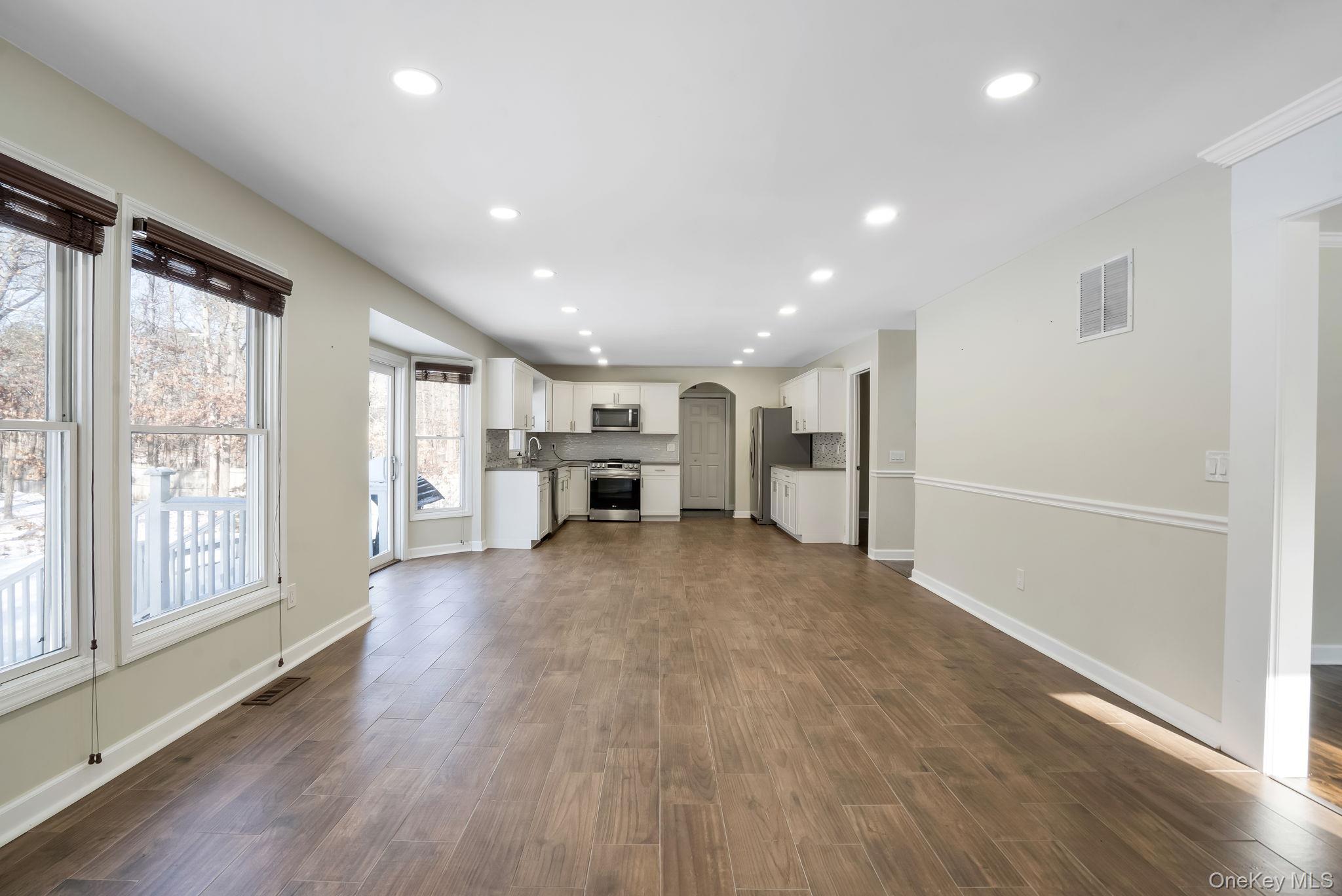 400 Eastport Manor Road Manorville, NY 11949 - Photo 7 of 29 a view of empty room with wooden floor and window