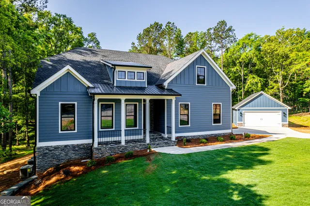 an aerial view of a house with a yard basket ball court and outdoor seating