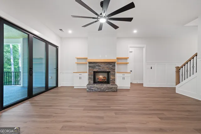 a kitchen with a sink stainless steel appliances a chandelier and wooden floor