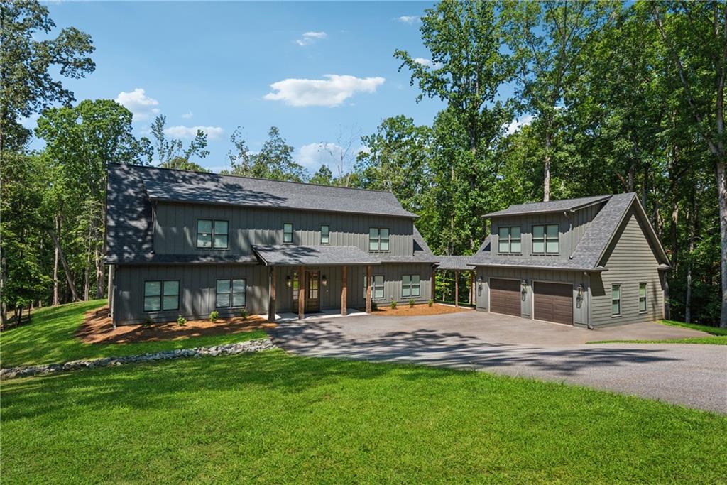 a view of a house with a yard porch and sitting area