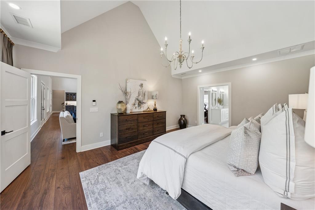3394 Robinson Road Gainesville, GA 30506 - Photo 23 of 51 a spacious bedroom with a bed and a chandelier