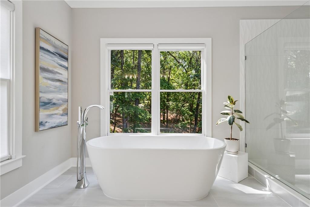 3394 Robinson Road Gainesville, GA 30506 - Photo 26 of 51 a white bath tub sitting in a bathroom next to a window