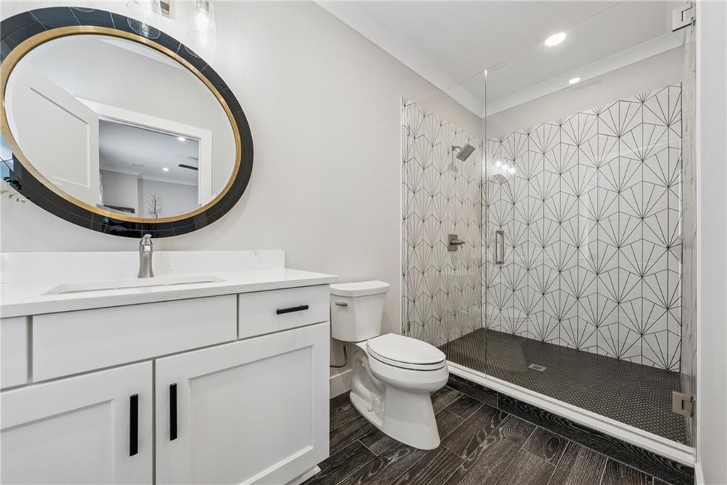 3394 Robinson Road Gainesville, GA 30506 - Photo 30 of 51 a bathroom with a toilet a sink and a mirror
