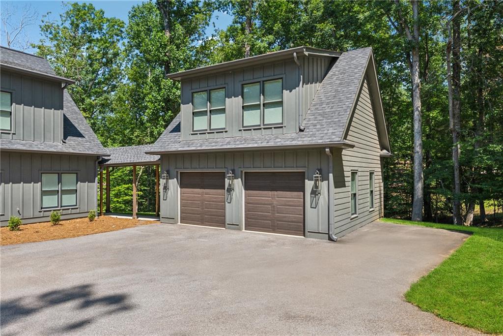 3394 Robinson Road Gainesville, GA 30506 - Photo 3 of 51 a front view of a house with a garden and trees