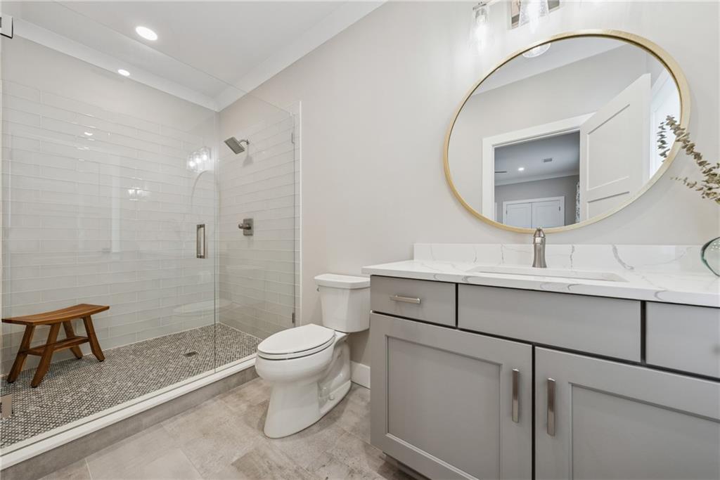 3394 Robinson Road Gainesville, GA 30506 - Photo 32 of 51 a bathroom with a sink a toilet and a mirror