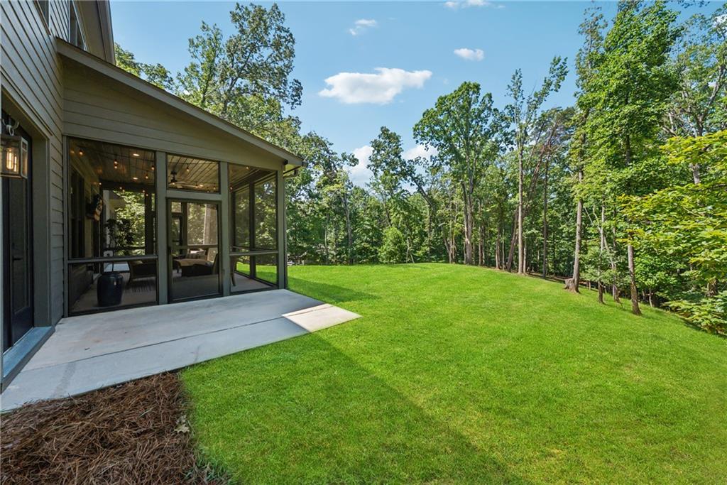 3394 Robinson Road Gainesville, GA 30506 - Photo 39 of 51 a view of a patio with table and chairs potted plants and large tree