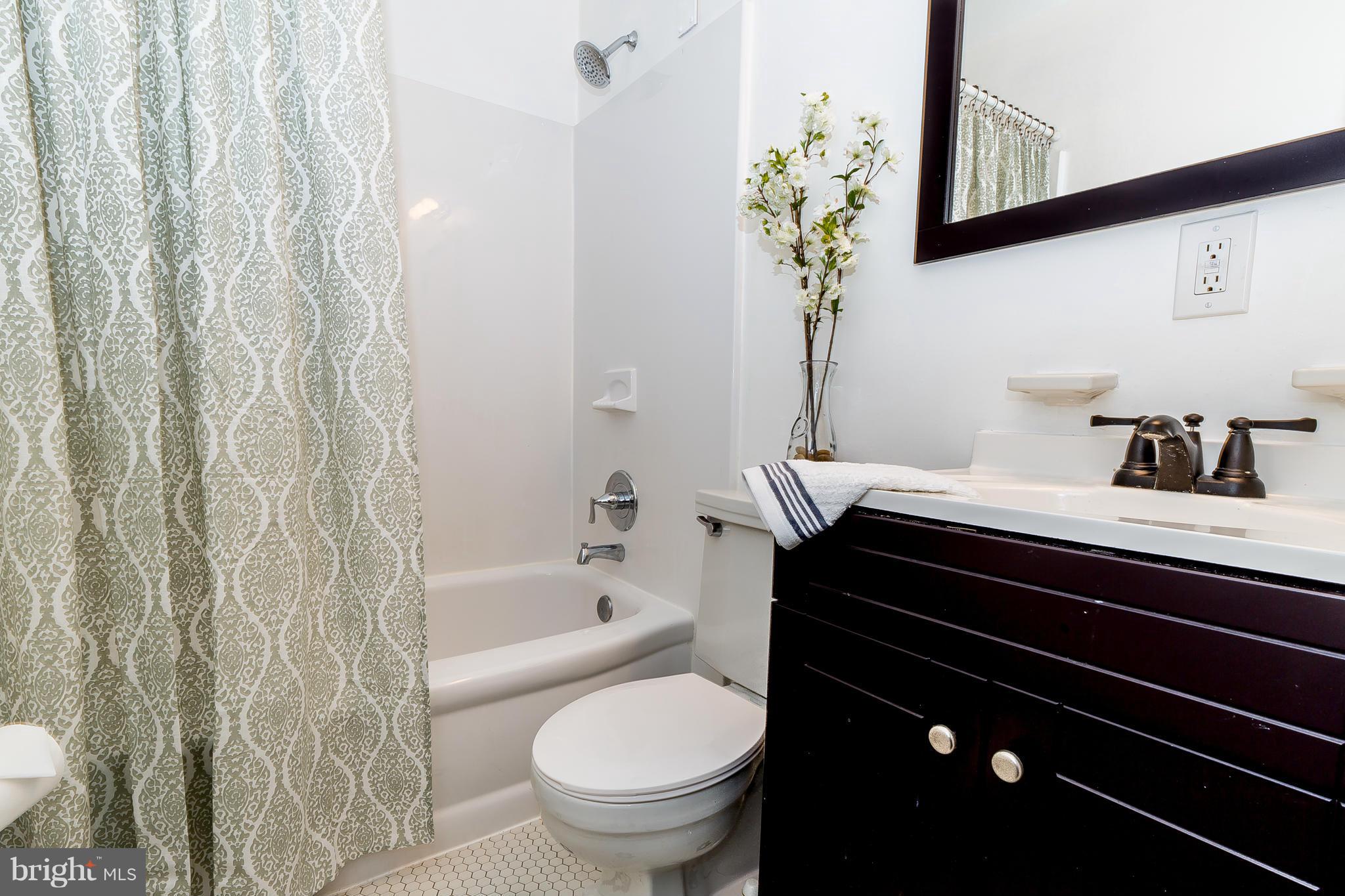 3417 Dunran Road Dundalk, MD 21222 - Photo 16 of 29 a bathroom with a sink a toilet and shower