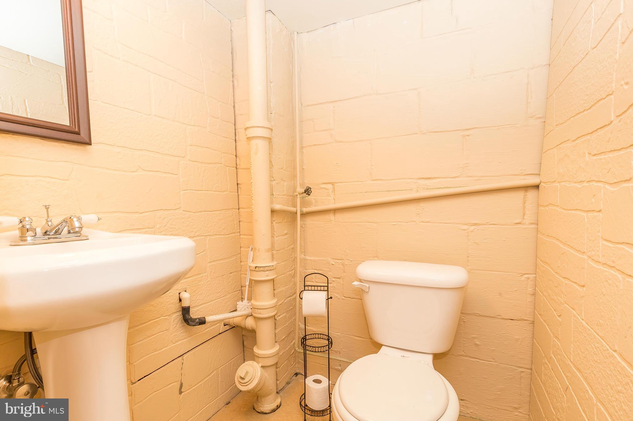 3417 Dunran Road Dundalk, MD 21222 - Photo 25 of 29 a bathroom with a toilet sink and mirror