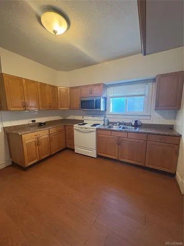 a kitchen with stainless steel appliances granite countertop a stove sink and cabinets