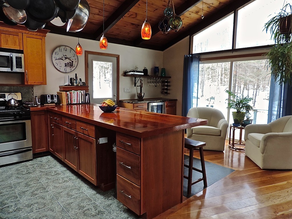 139 Bug Hill Road Ashfield, MA 01330 - Photo 7 of 28 a kitchen with stainless steel appliances granite countertop a stove a sink dishwasher and cabinets with wooden floor
