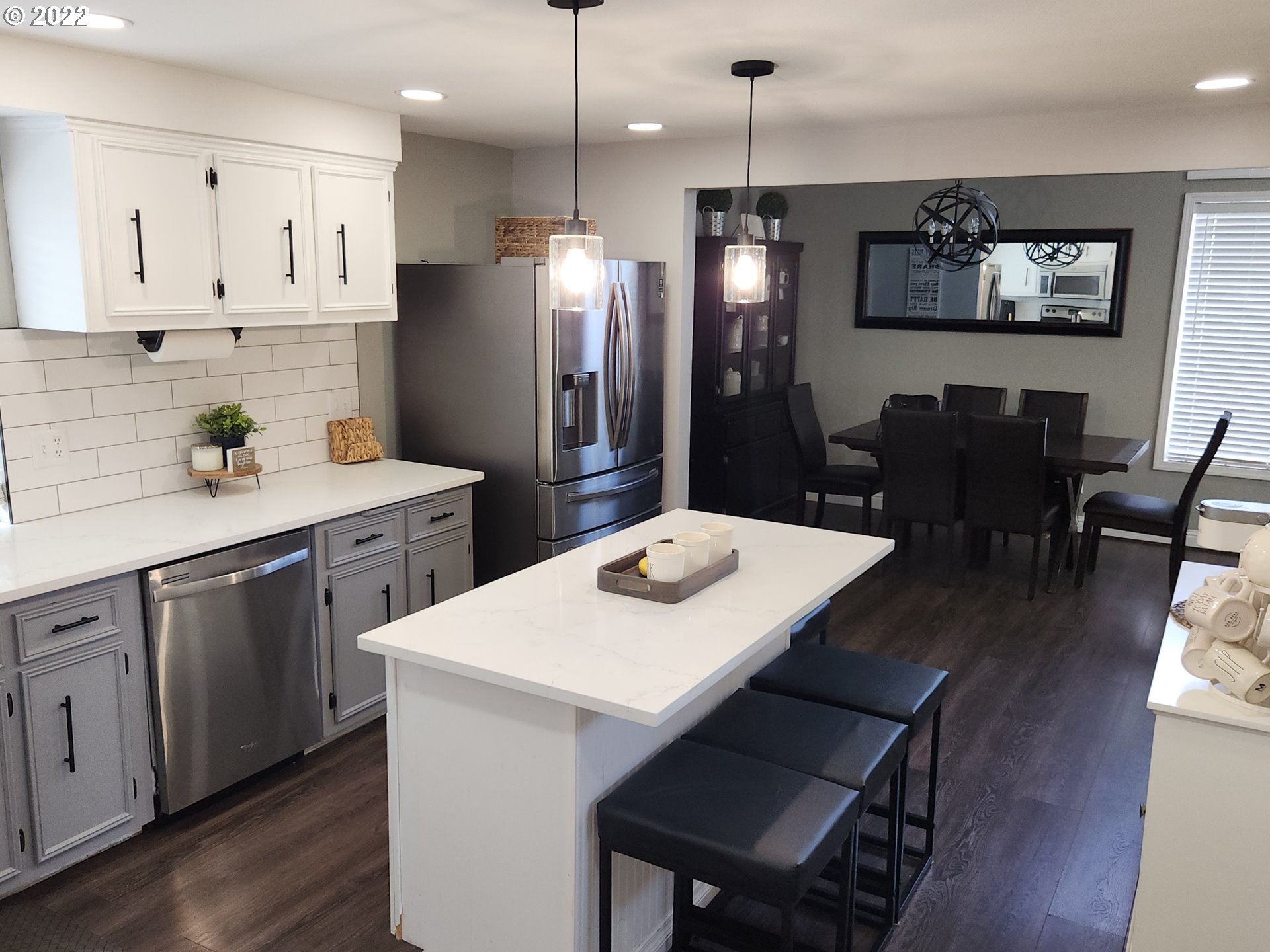 480 72nd Street Springfield, OR 97478 - Photo 11 of 24 a kitchen with stainless steel appliances a stove a sink a refrigerator a dining table and chairs