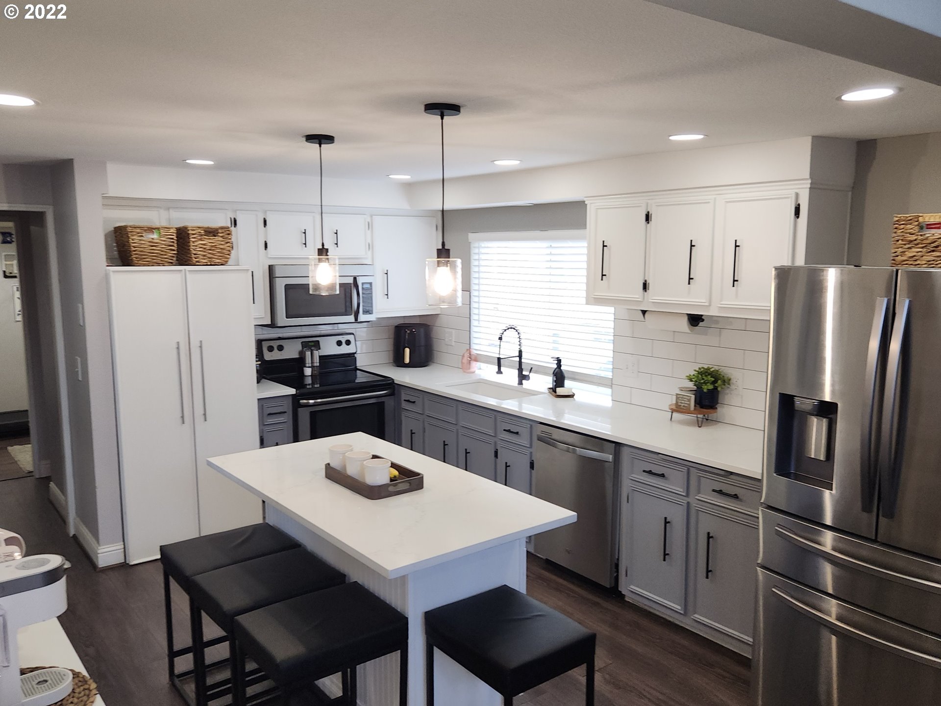 480 72nd Street Springfield, OR 97478 - Photo 10 of 24 a kitchen with stainless steel appliances a refrigerator a sink a stove a table and chairs