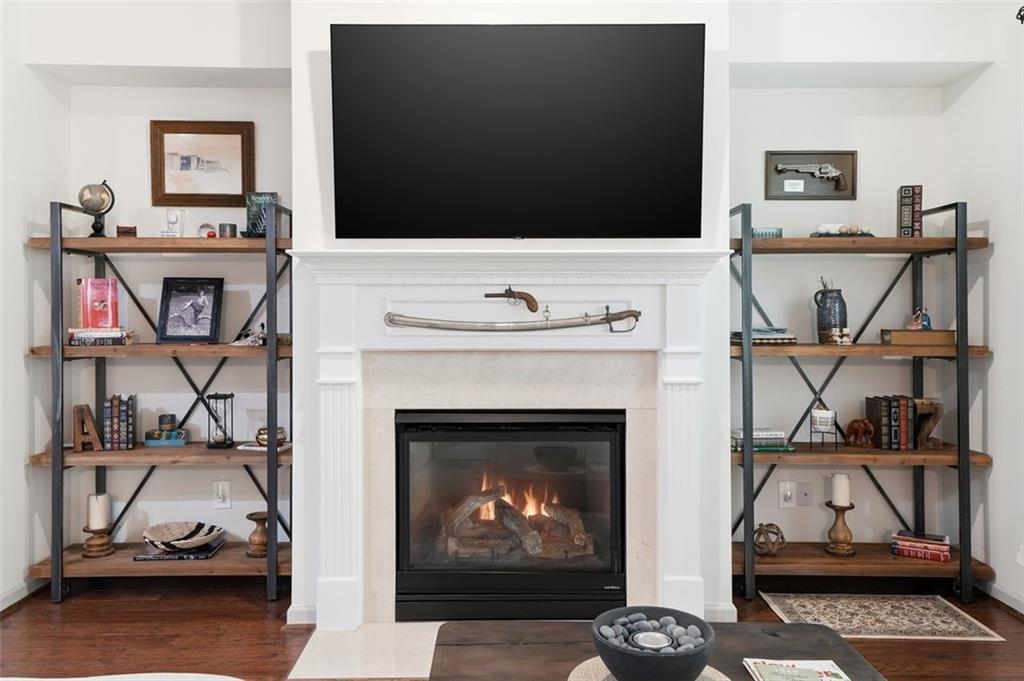1114 Firethorne Pass Cumming, GA 30040 - Photo 11 of 43 a living room with furniture a flat screen tv and a fireplace